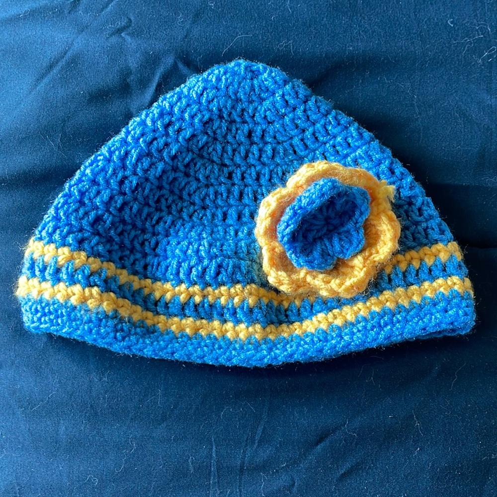 Handmade blue and yellow winter knit cap with flower detail